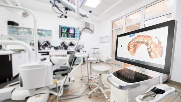 Digital model of row of teeth on computer monitor in dental treatment room