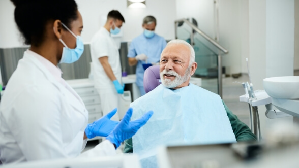 Senior dental patient listening to his dentist