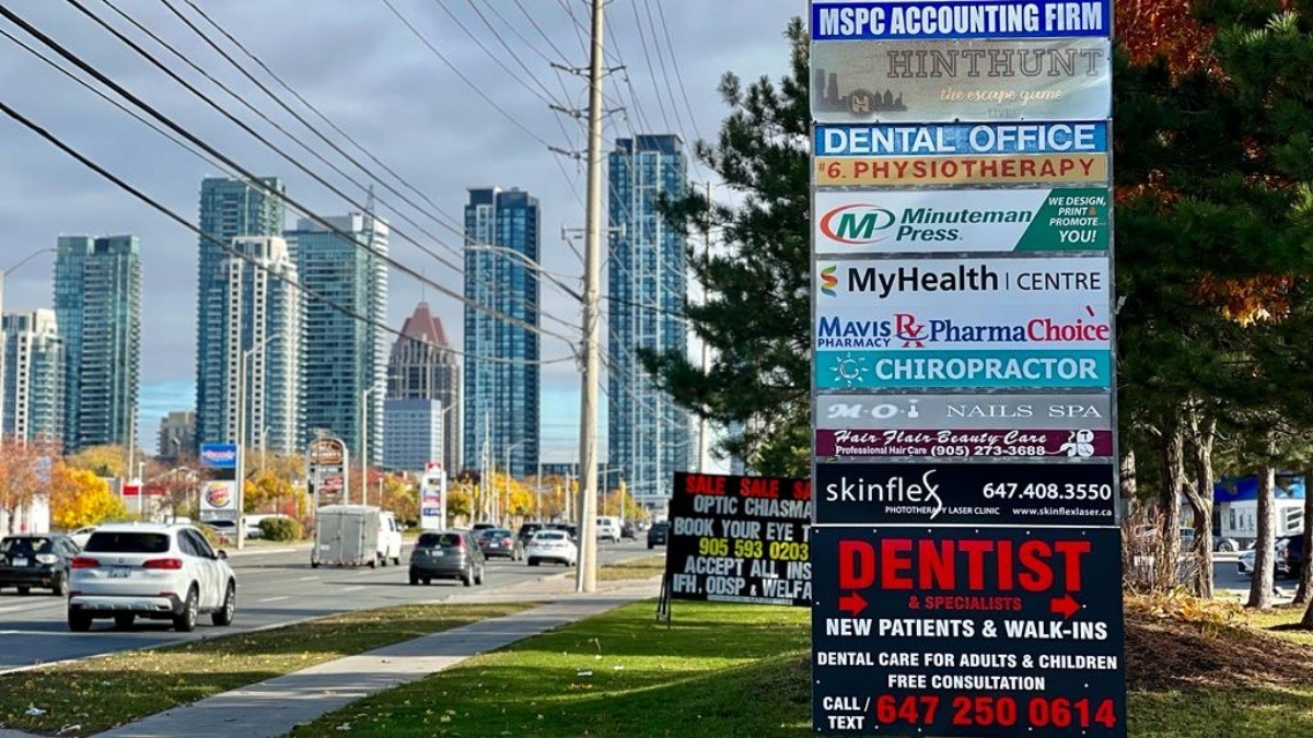 Business signs with skyscrapers in background